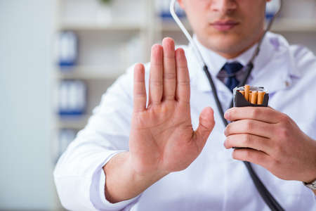 Male doctor in anti-smoking conceptwithcigarette packの写真素材