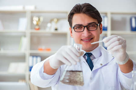 Young researcher scientist doing a water test contamination experiment in the laboratory