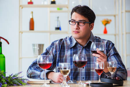 Professional sommelier tasting red wineの写真素材