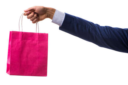 Hand holding shopping bags with christmas shopping on white backgroundの写真素材