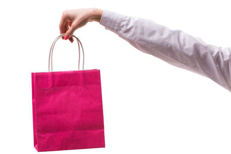 Hand holding shopping bags with christmas shopping on white backgroundの写真素材
