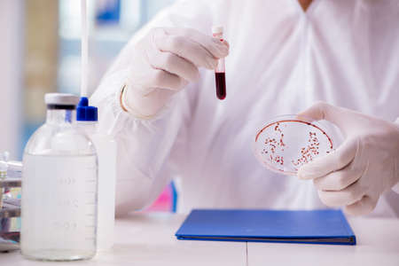 Chemist working in the laboratory with hazardous chemicals