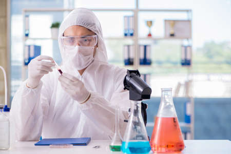 Chemist working in the laboratory with hazardous chemicals
