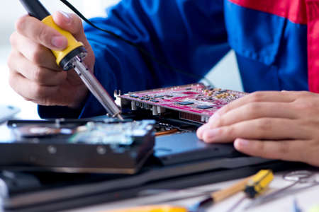 Repairman working in technical support fixing computer laptop tr