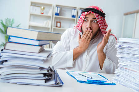 Arab businessman working in the office doing paperwork with a piの写真素材
