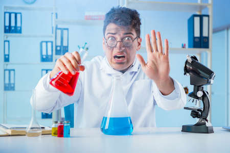 Funny mad chemist working in a laboratoryの写真素材