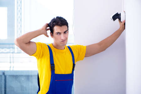 Contractor installing surveillance CCTV cameras in office