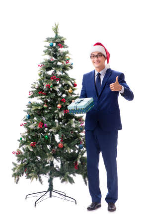 Businessman decorating christmas tree isolated on whiteの写真素材