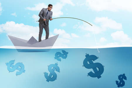 Businessman fishing dollars money from paper boat shipの写真素材