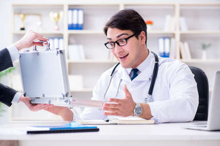 Young doctor in medical insurance fraud conceptの写真素材