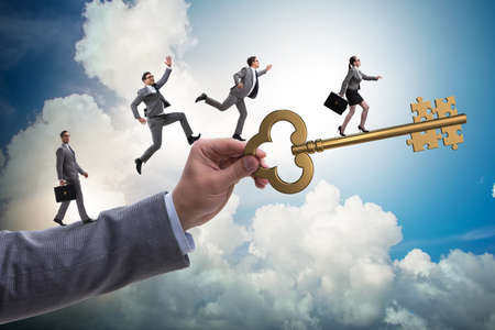 Business people chasing each other towards key to successの写真素材