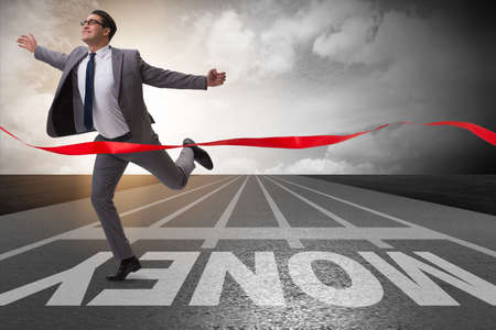 Young businessman chasing money in financial business conceptの写真素材