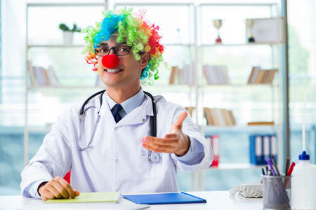 Funny pediatrician with clown wig in the hospital clinicの写真素材