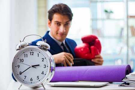 Man with boxing gloves in the officeの写真素材