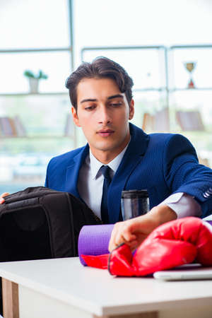 Man with boxing gloves in the officeの写真素材