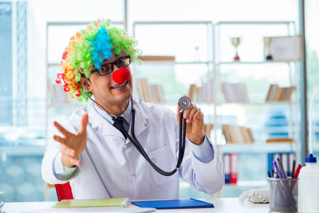 Funny pediatrician with clown wig in the hospital clinicの写真素材