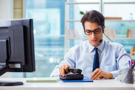 Unhappy angry call center worker frustrated with workloadの写真素材