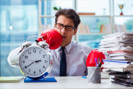 Businessman with boxing gloves in the officeの写真素材