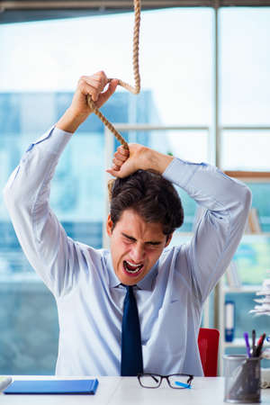 Concept of overworked businessman with noose around his neckの写真素材