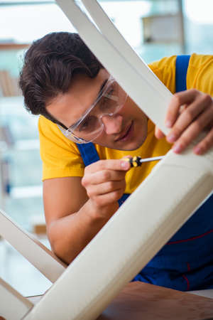 Furniture repairman working on repairing the chairの写真素材