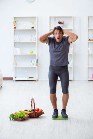 Man promoting the benefits of healthy eating and doing sportsの写真素材