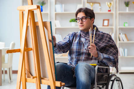 Disabled artist painting picture in studioの写真素材