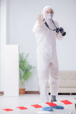 Forensic expert at crime scene doing investigationの写真素材