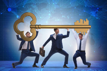 Businessmen holding giant key in business conceptの写真素材