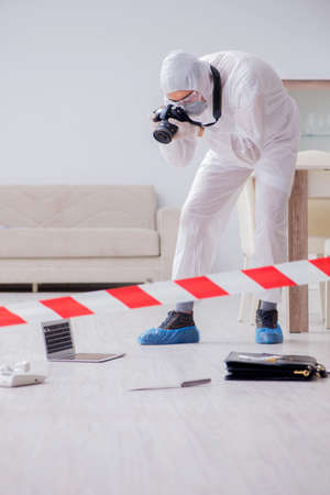 Forensic expert at crime scene doing investigationの写真素材