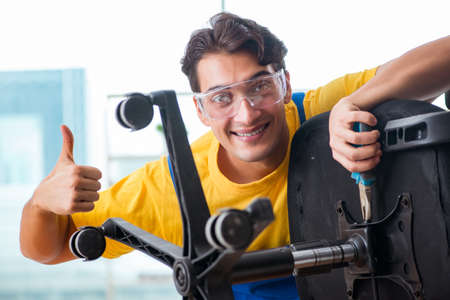Furniture repairman working on repairing the chairの写真素材