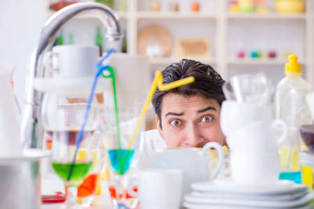 Man frustrated at having to wash dishesの写真素材