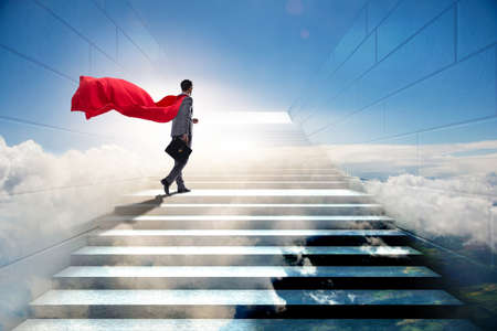 Businessman superhero successful in career ladder conceptの写真素材