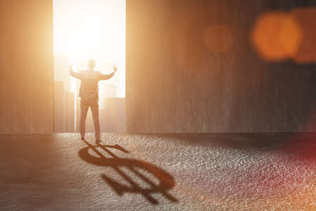 Businessman casting dollar shape shadow in business concept