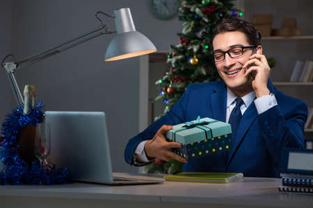 Businessman working late on christmas day in officeの写真素材