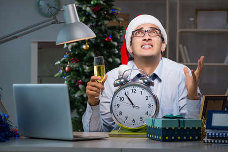 Businessman working late on christmas day in officeの写真素材