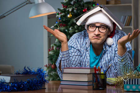 Young man working at home on christmas dayの写真素材