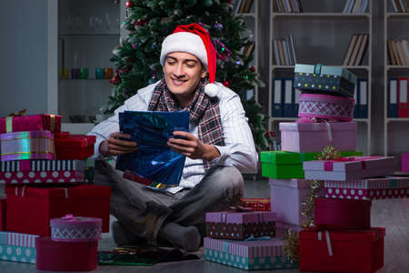 Man with many christmas gifts in boxes