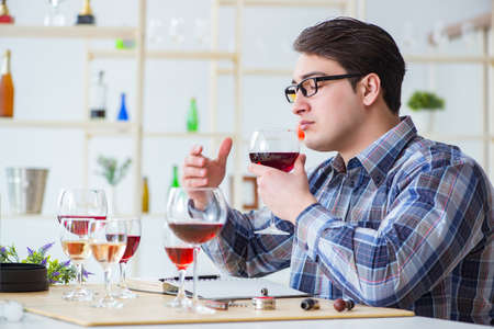 Professional sommelier tasting red wine