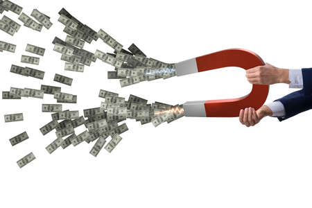 Businessman catching dollars on horseshoe magnetの写真素材