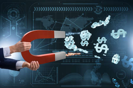 Businessman catching dollars on horseshoe magnetの写真素材