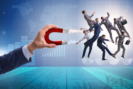 Businessman in recruitment concept with horseshoe magnetの写真素材