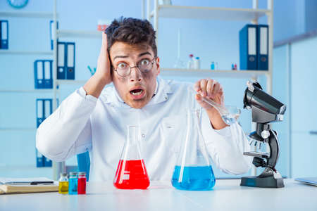 Funny mad chemist working in a laboratory