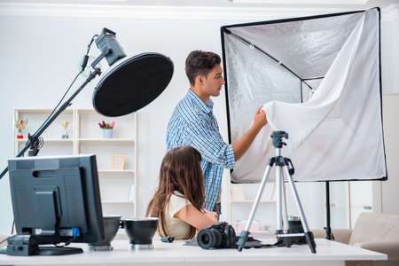 Young photographer working in photo studio