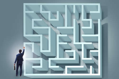 Businessman is trying to escape from maze labyrinthの写真素材