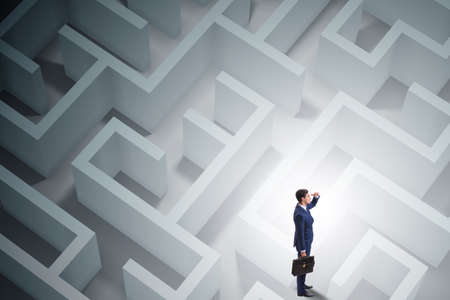 Businessman is trying to escape from maze labyrinthの写真素材