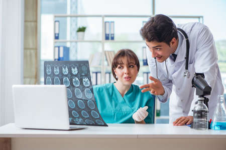 Two doctors discussing x-ray MRI image in hospital