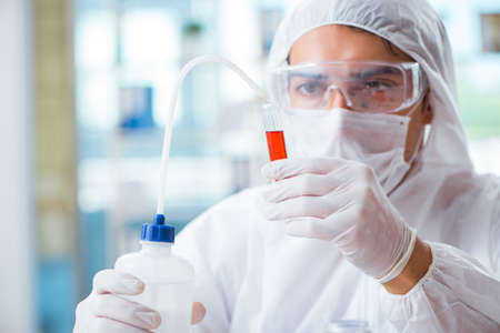 Chemist working in the laboratory with hazardous chemicals
