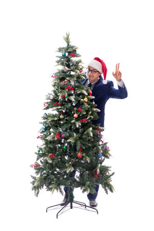 Businessman decorating christmas tree isolated on whiteの写真素材