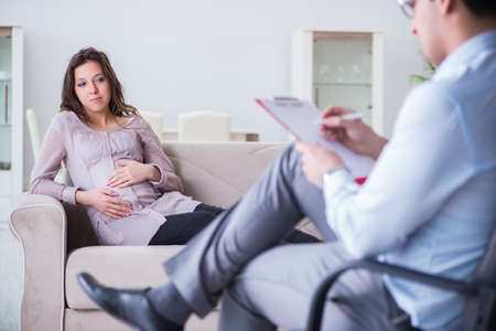 Pregnant woman visiting psychologist doctorの写真素材