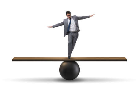 Businessman balancing on seesaw in uncertainty concept